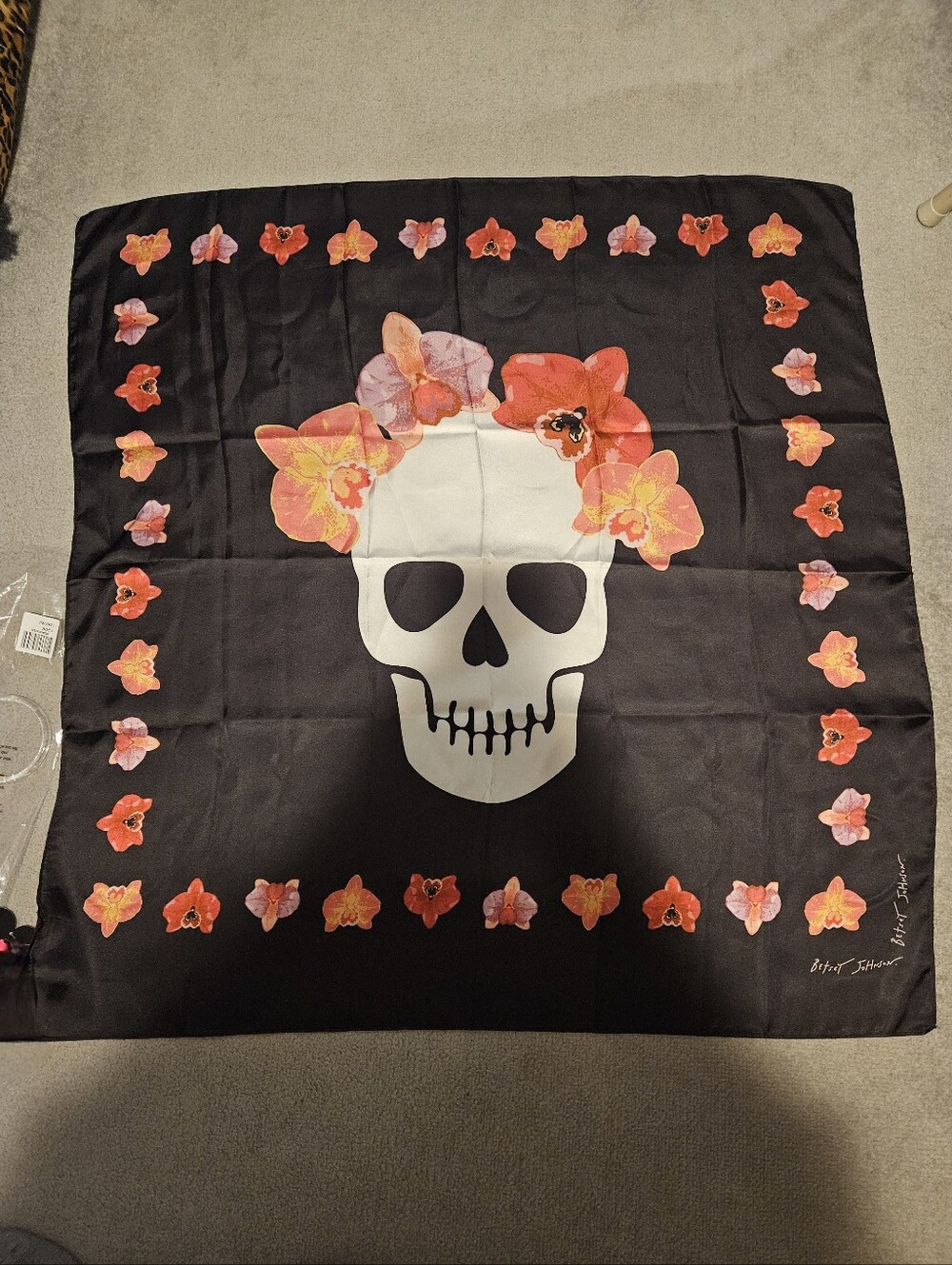 Betsey Johnson 100% polyester black scarf with skull and flowers.